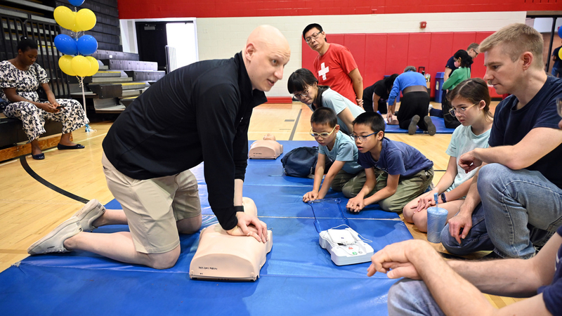 Experts from MedStar Health participate in a community health event to teach how to perform CPR and use an AED in an emergency.