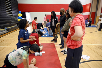 Experts from MedStar Health participate in a community health event to teach how to perform CPR and use an AED in an emergency.