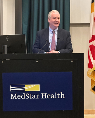 Maryland Senator Chris Van Hollen speaks at a podium at MedStar Health.