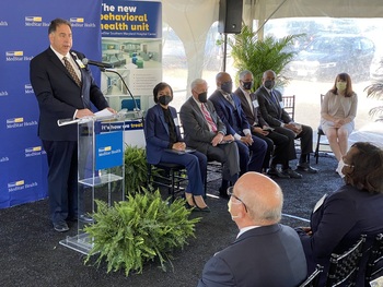 Stephen Michaels speaks at a podium during the opening of the newly rennovated Behavioral Health unit at MedStar Southern Maryland Hospital Center on May 10, 2022.