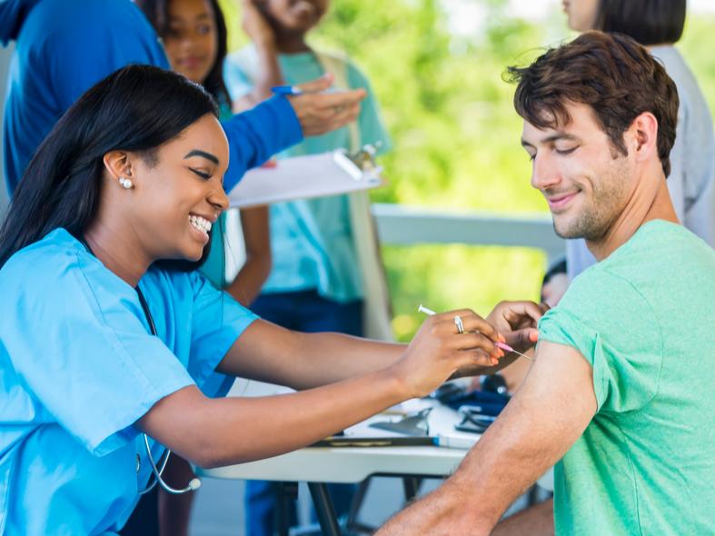 Man receives immunization from at vaccination clinic