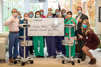 The NICU team from MedStar Franklin Square Medical Center holds an oversized donation check from Celebree School, which was used to purchase new fetal monitoring machines.