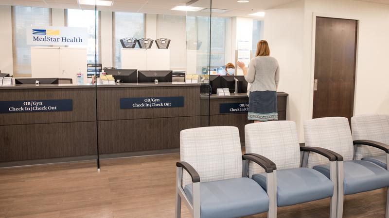 A patient stands at the reception desk at MedStar Health OBGYN at Glover Park.