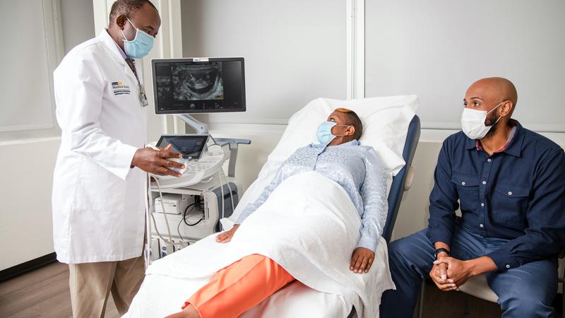 A doctor talks with a patient and her husband at the MedStar Health Obgyn office at Glover Park.