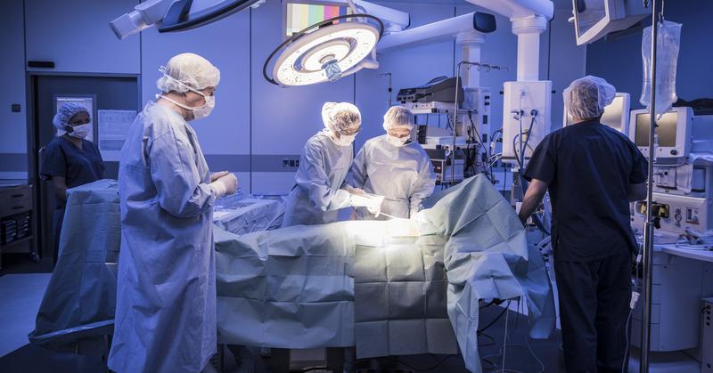 A surgical team works in the operating room at a hospital.