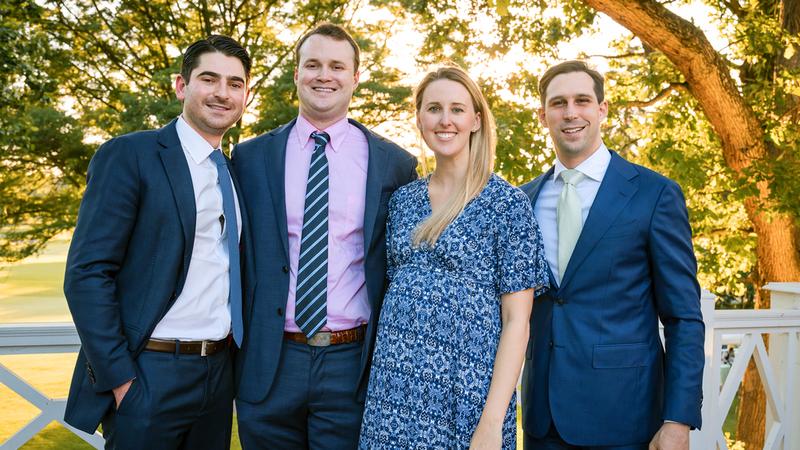 Four chief residents wearing white lab coats from the Orthopedic Residency Program in Washington DC stand together outdoors for a group photo.