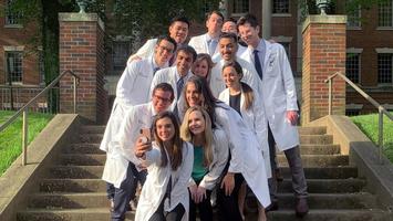 A group of residents from the MedStar Health Otolaryngology Head and Neck Residency program stand together for a group photo outdoors.