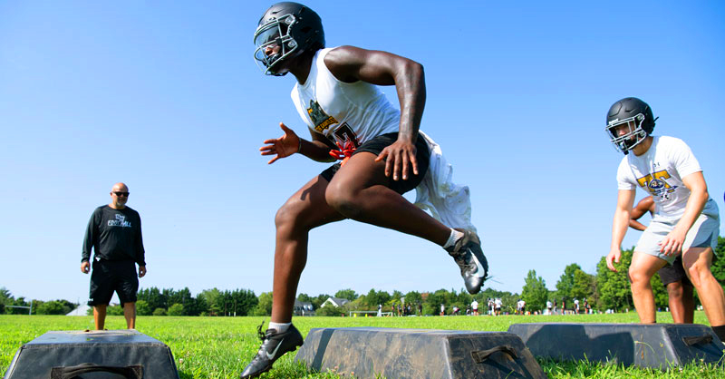 Youth football players from Montgomery County, Maryland, run on their practice field.