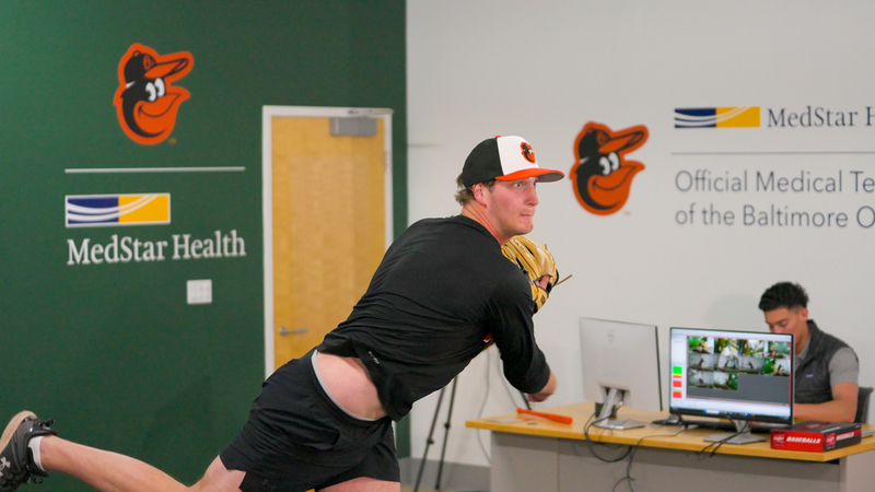 A pitcher for the Baltimore Orioles throws a pitch at the MedStar Health pitching lab.