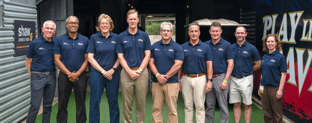 The MedStar Health physician team for the Baltimore Ravens football team poses for a photo on the field before a game.