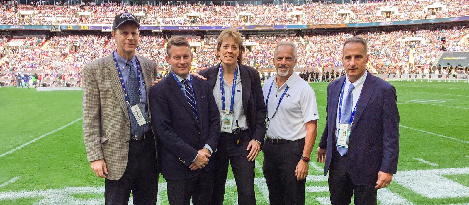 The MedStar Health physician team for the Baltimore Ravens football team poses for a photo on the field before a game.