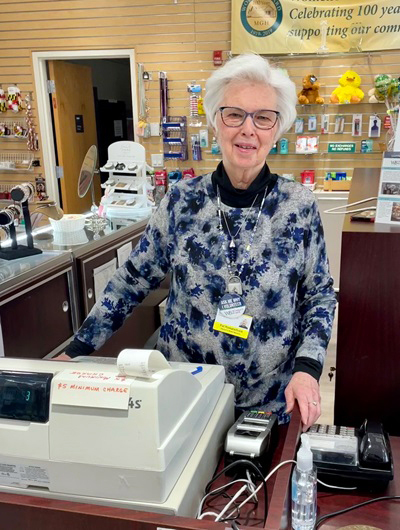 Patricia (Pat) Romanchock poses for a photo in the gift shop at MedStar Mongomery Medical Center.