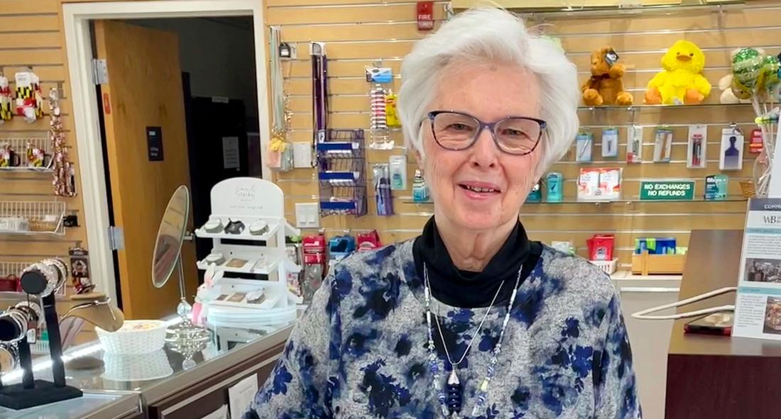 Patricia (Pat) Romanchock poses for a photo in the gift shop at MedStar Mongomery Medical Center.