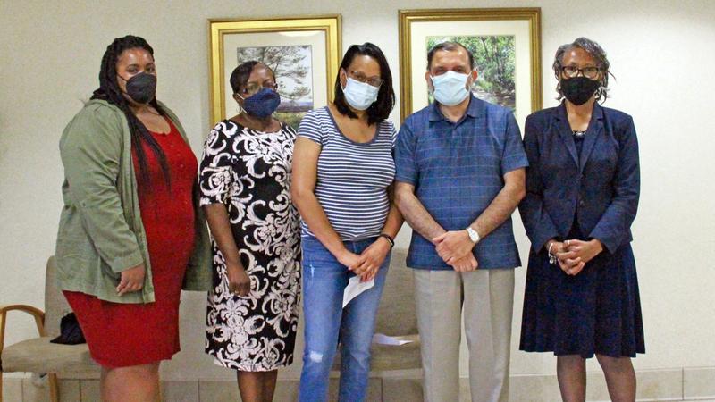 5 people wearing masks pose for a photo at MedStar St. Mary's Hospital.