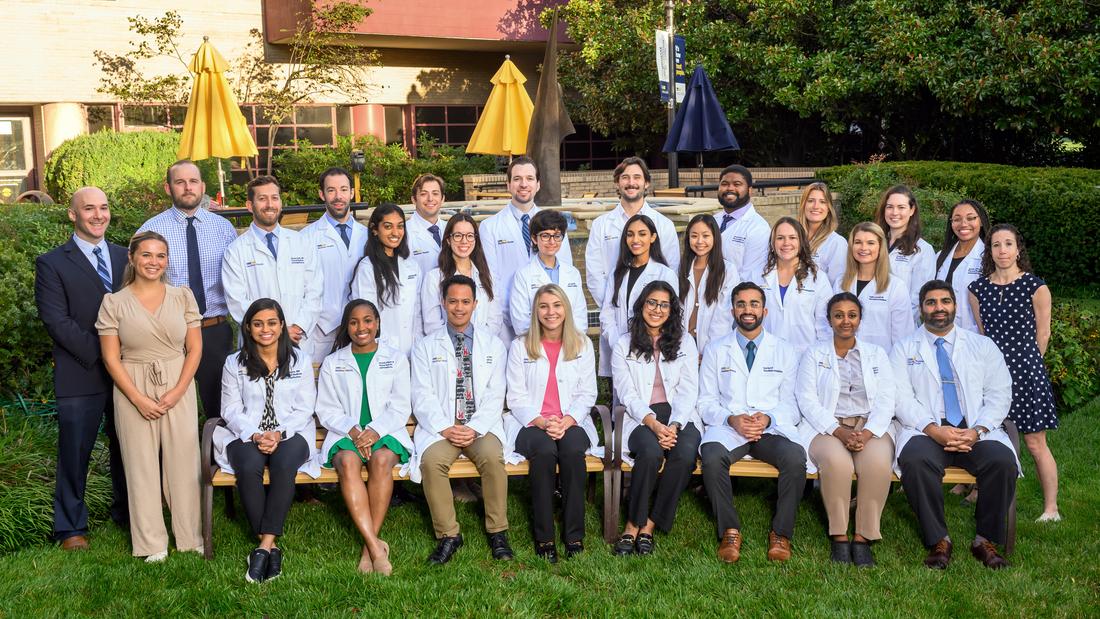 A group of residents from the MedStar Health Physical Medicine and Rehabiltation Residency Program pose for a formal group photo outdoors.