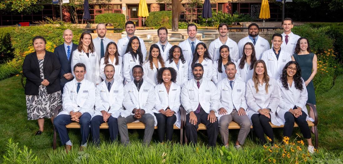 A group of residents from the MedStar Health Physical Medicine and Rehabiltation Residency Program pose for a formal group photo outdoors.