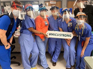 A team from the Medical Intensive Care Unit at MedStar Georgetown University Hospital poses for a photo wearing PPE equipment.