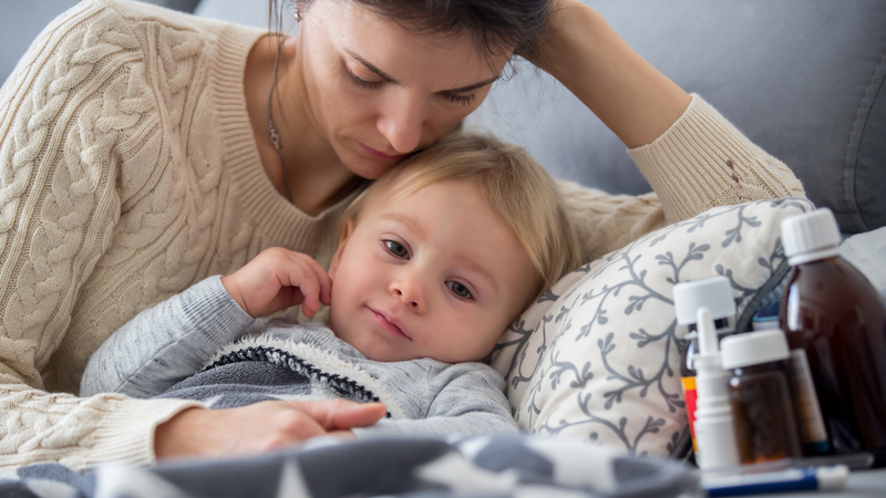 A mother comforts her sick child.