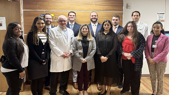 A group of residents and faculty from the Radiology Oncology Residency Program at MGUH poses for a photo outdoors.