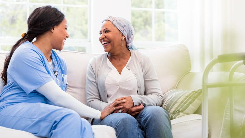 A nurse talks with a female cancer patient.