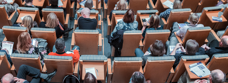 Overhead photo of audience members during a presentation.