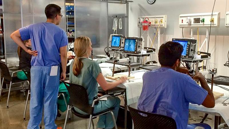 Group photo of students in MedStar Health's Otolaryngology Head and Neck Surgery Residency program work together in a classroom.