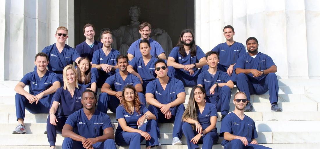 A group of residents from the MedStar Health Physical Medicine and Rehabiltation Residency Program sit on the steps of the Lincoln Memorial in Washington DC.
