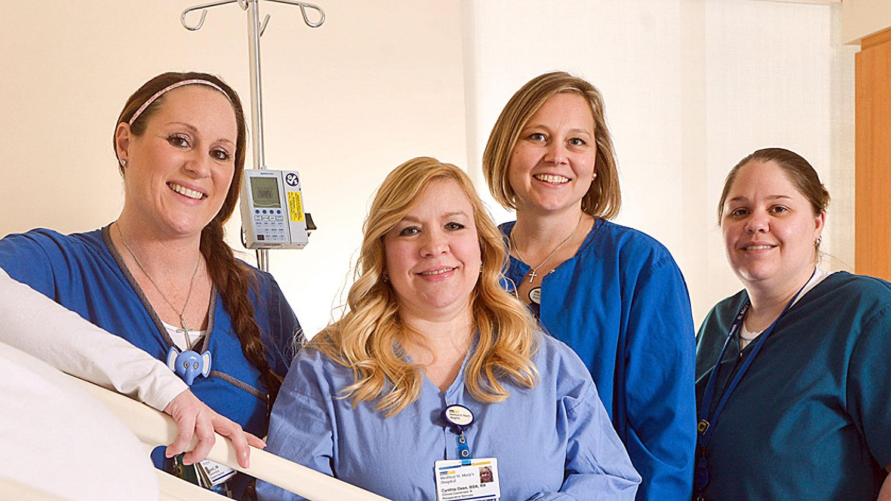 4 nurses pose for a group portrait inside of a MedStar Health hospital.