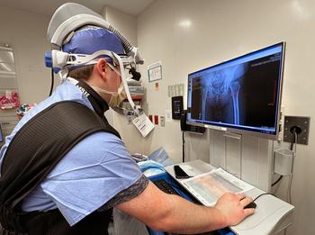 An orthopedic surgeon checks a scan on a computer monitor during a procedure at MedStar Health
