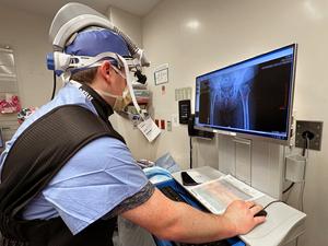 An orthopedic surgeon checks a scan on a computer monitor during a procedure at MedStar Health