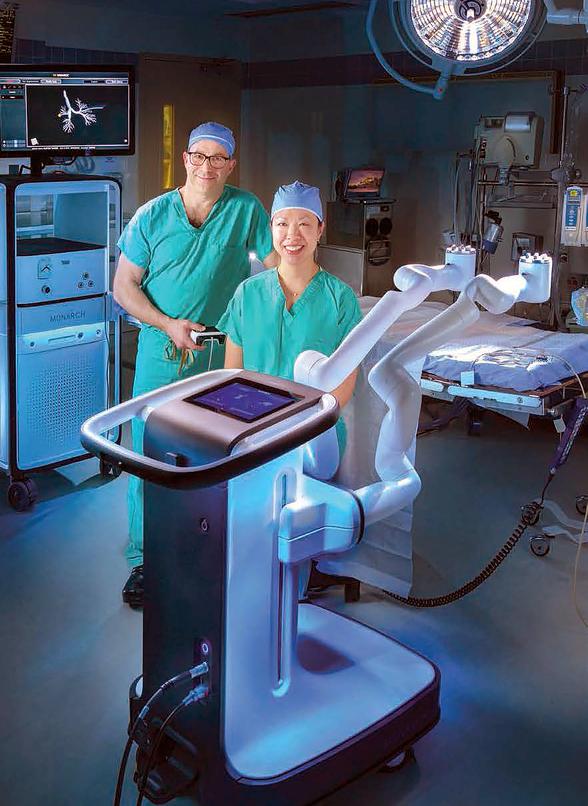 Doctors John Lazar and Jessica Wang Memoli stand and pose for a portrait in an operating room at MedStar Washington Hospital Center.