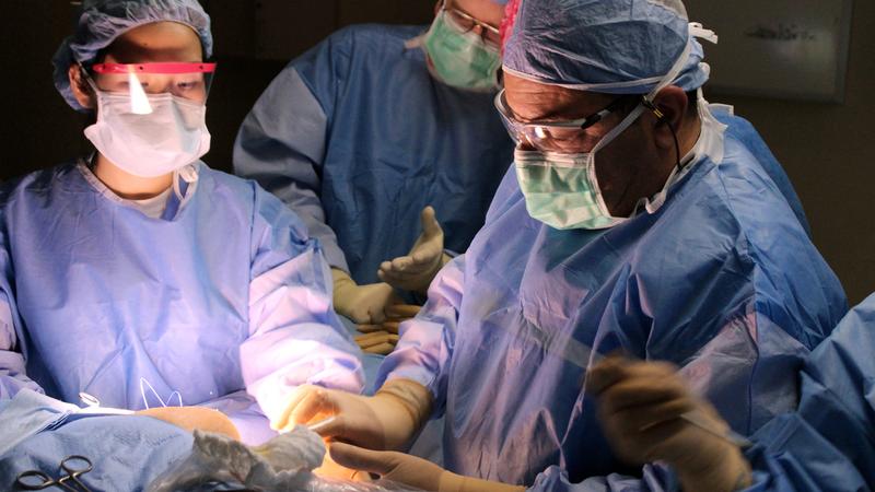 Dr. Maen Farha and his team perform surgery in an operating room at a MedStar Health hospital. 
