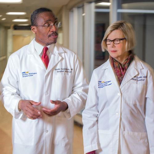 Doctors Ihemelandu and Swain talk while walking through the hallway at MedStar Washington Hospital Center.