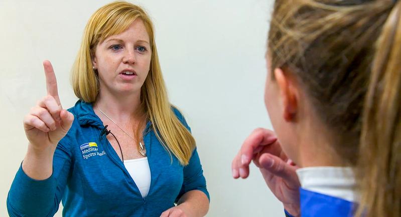 Dr Kelly Ryan performs a concussion evaluation for a female athlete.