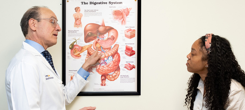 Dr. Paolo Peghini, a gastroenterologist at MedStar Health, talks with a patient during an office visit.