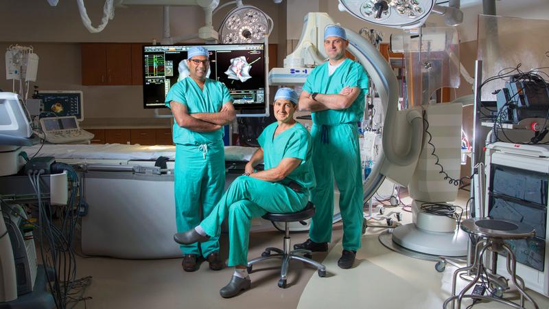 Doctors Eldadah, Schults and Shah pose for a photo in the cardiac electrophysiology lab at MedStar Washington Hospital Center.