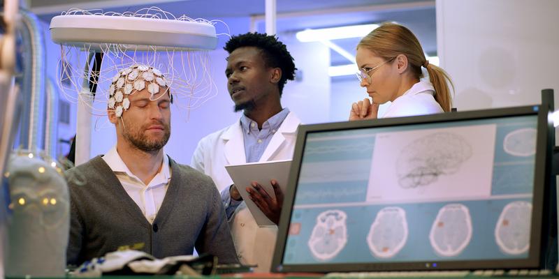 A patient undergoes an enlectroencephalogram (EEG) in a clinical setting.)