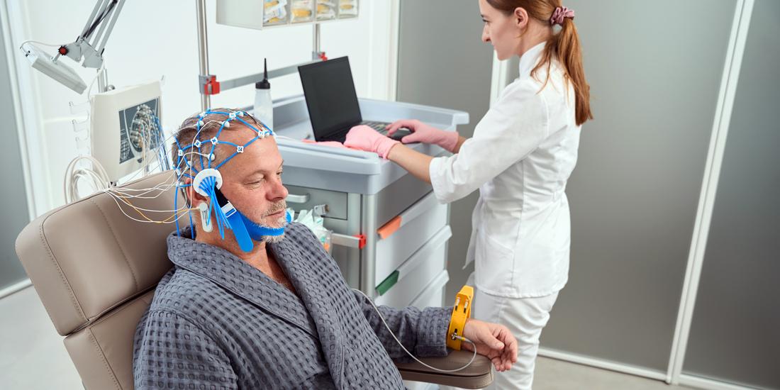 A patient undergoes an enlectroencephalogram (EEG) in a clinical setting.)