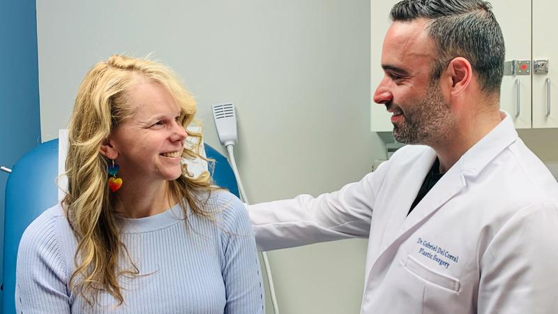 Dr. Andrew Hodge and Dr. Gabriel DelCorral have a conversation in the hallway of the MedStar Health Center for Gender Affirmation in Baltimore, Maryland.