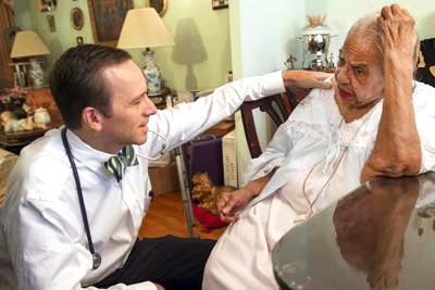 Dr Eric DeJonge consults with a patient to help manage medications during a house call visit.