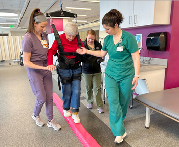 Physical therapists work with a patient in the rehabilitation gym at MedStar National Rehabilitation Hospital.