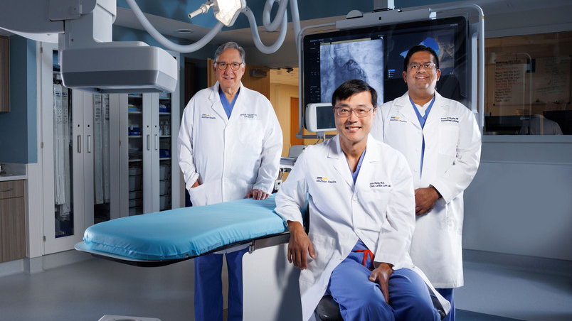 A team of interventional cardiologists from MedStar Unioin Memorial Hospital pose for a photo in an operating room.