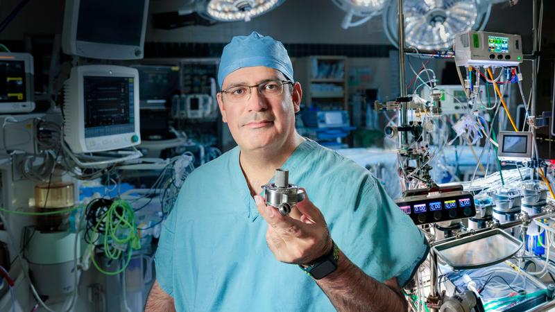 Dr Keki Balsara holds an LVAD device.