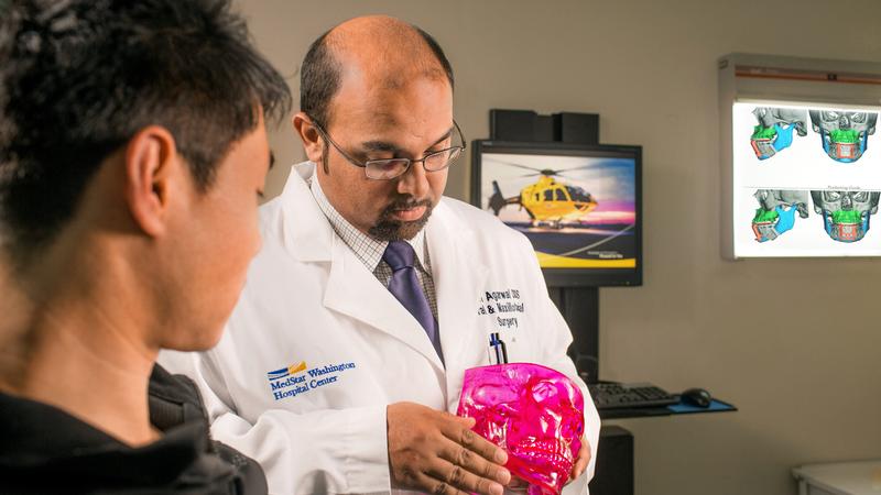 Dr Ravi Agarwal talks with a patient during an office visit.