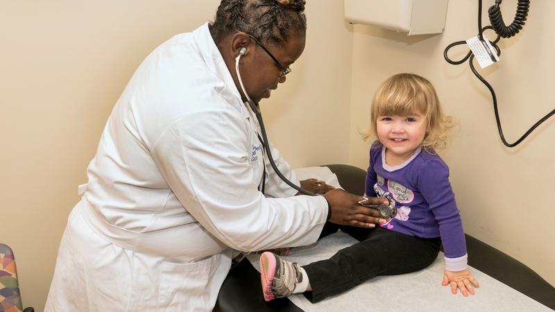 Dr. Tia Medley listens to the heart of a young patient during an office visit at MedStar Health.