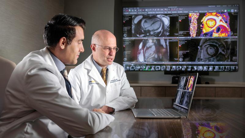 Program Director S. Wagas Haider, MD, and Gabby Weisman, MD, view image of the heart of a patient with pericardial disease.