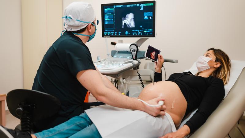 An ultrasound technician and a female patient.