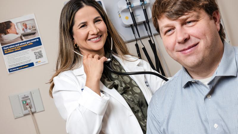 Dr. Nitika Paudel listens to a patient's lungs during an office visit at MedStar Health.