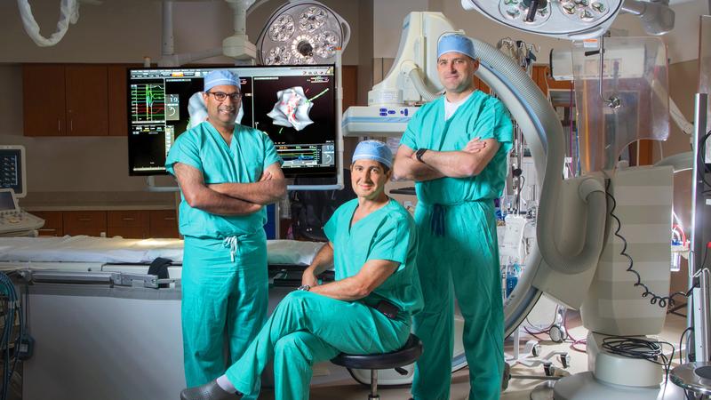 Doctors Eldadah, Schults and Shah pose for a photo in the cardiac electrophysiology lab at MedStar Washington Hospital Center.