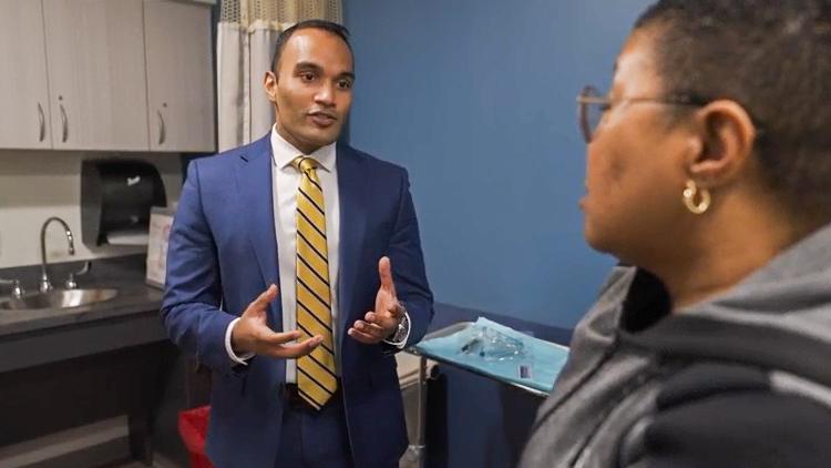 Dr. Mohit Gupta talks with a patient during an office visit.